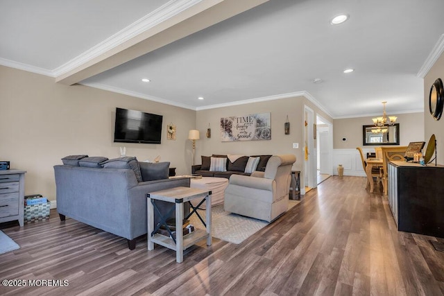 living room featuring crown molding, recessed lighting, a notable chandelier, and wood finished floors