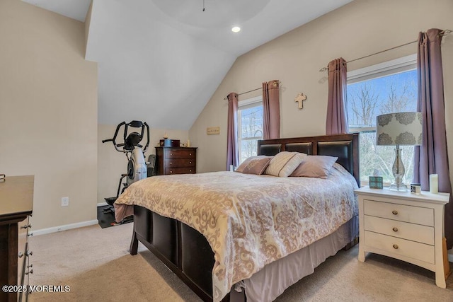 bedroom with vaulted ceiling, baseboards, and light colored carpet