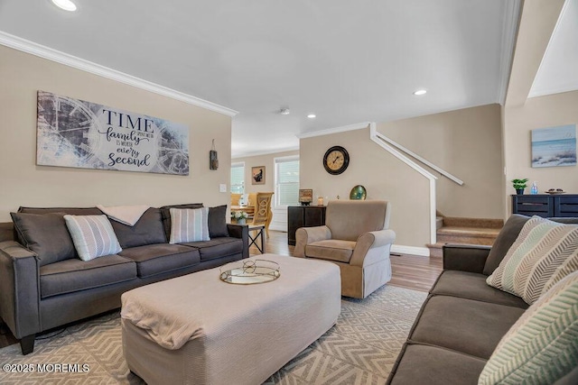 living room with stairs, light wood-style flooring, and crown molding