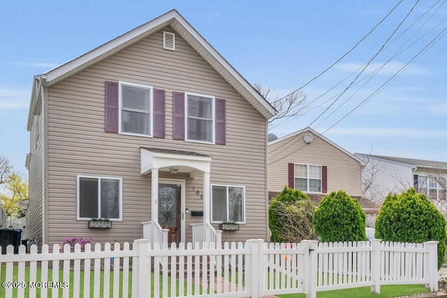 traditional-style home with a fenced front yard