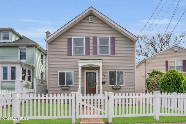 traditional-style house with a fenced front yard