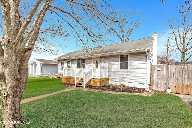 single story home featuring a chimney, a front yard, and fence