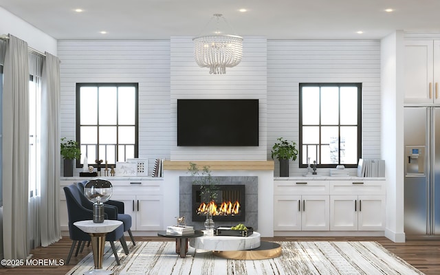 living room with light wood-style floors, recessed lighting, a chandelier, and a fireplace