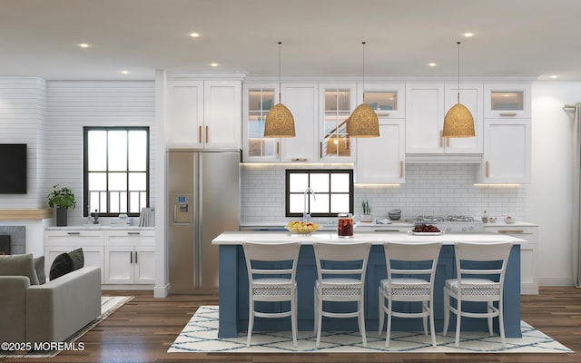 kitchen featuring white cabinets, stainless steel fridge with ice dispenser, a kitchen island, glass insert cabinets, and dark wood-type flooring