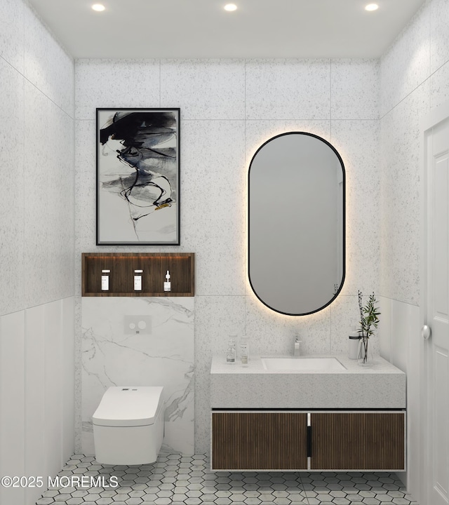 bathroom with tile walls, vanity, toilet, and recessed lighting