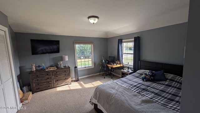 carpeted bedroom featuring baseboards
