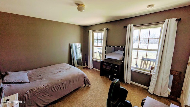 bedroom featuring baseboards and carpet floors