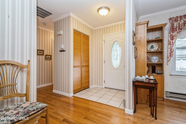 entryway with a wealth of natural light, light wood-style flooring, and crown molding