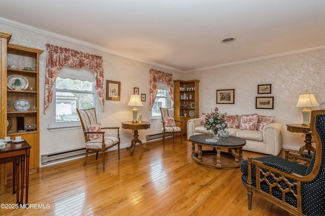 living room with ornamental molding, light wood-type flooring, and plenty of natural light