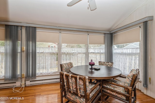 dining area with plenty of natural light, vaulted ceiling, and light wood-style flooring