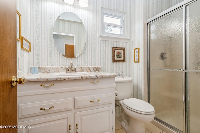 bathroom featuring toilet, wallpapered walls, vanity, and a stall shower