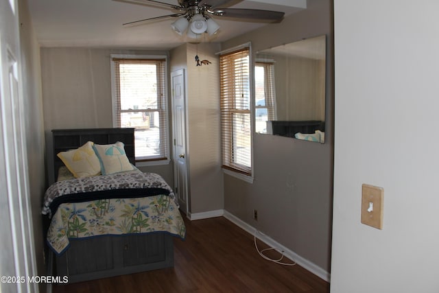 bedroom with a ceiling fan, baseboards, and wood finished floors