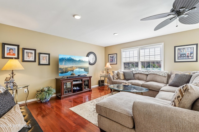 living area with wood finished floors, baseboards, and ceiling fan