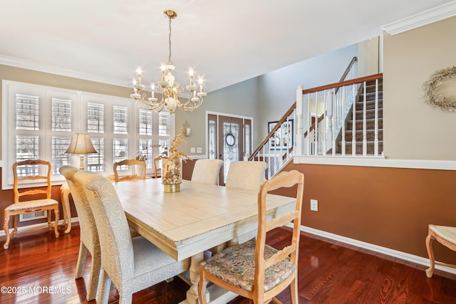 dining room with wood finished floors, baseboards, stairs, crown molding, and a notable chandelier