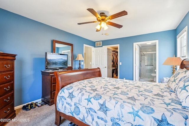 bedroom with visible vents, ensuite bathroom, carpet floors, baseboards, and a spacious closet