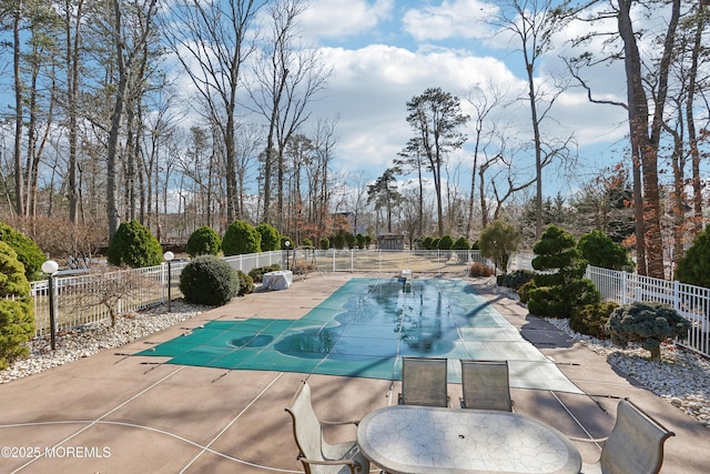 view of swimming pool featuring a fenced in pool, a patio, and fence