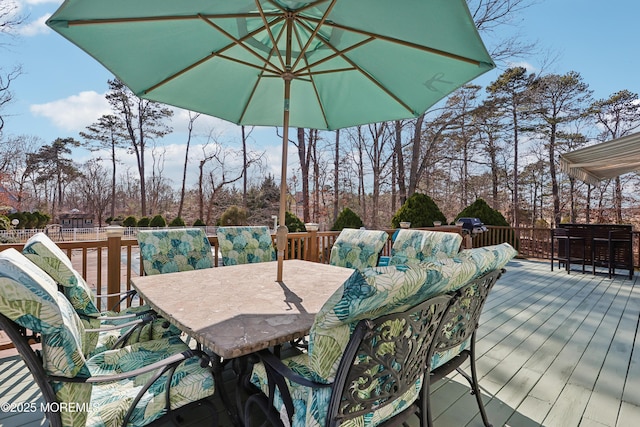 wooden terrace with outdoor dining area