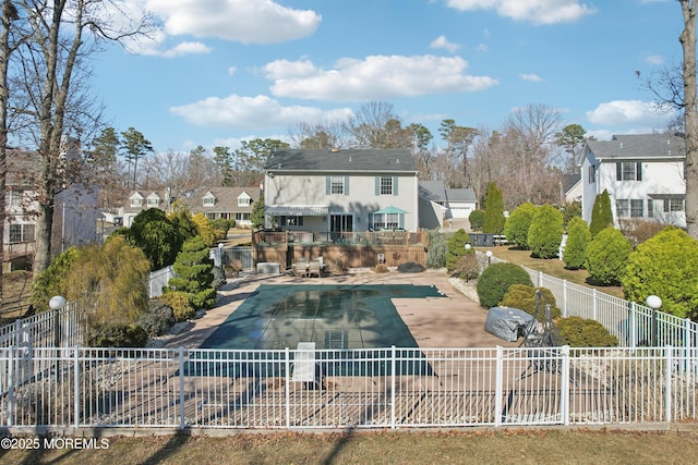 back of property with a patio area, a residential view, a fenced in pool, and fence