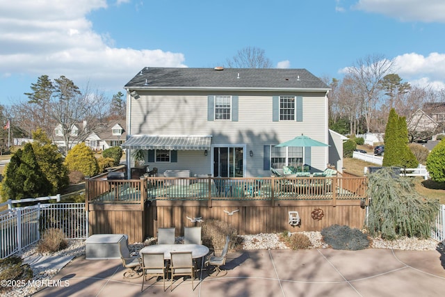 rear view of property featuring outdoor dining area, a patio area, a deck, and fence