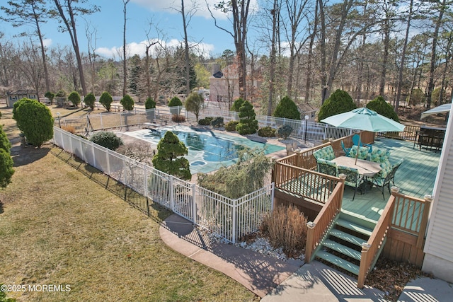 view of swimming pool with a lawn, fence, a fenced in pool, and a wooden deck