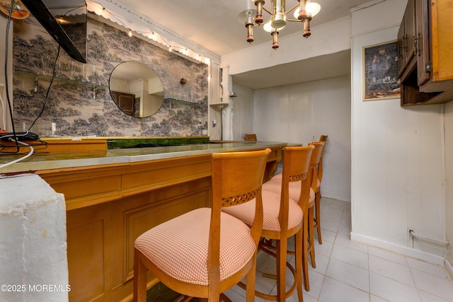 75 Highland Ave, Highlands, NJ 07732 - bar featuring an inviting chandelier, light tile patterned floors, and ornamental molding