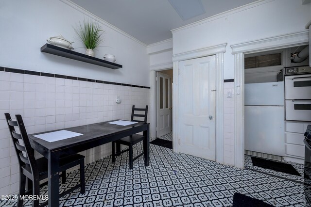 75 Highland Ave, Highlands, NJ 07732 - dining space with tile walls, ornamental molding, and wainscoting