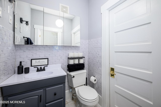 75 Highland Ave, Highlands, NJ 07732 - bathroom featuring visible vents, toilet, tile walls, and vanity