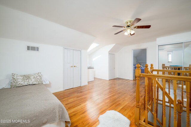 75 Highland Ave, Highlands, NJ 07732 - bedroom with visible vents, light wood-style flooring, ceiling fan, and vaulted ceiling