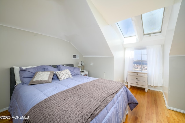 75 Highland Ave, Highlands, NJ 07732 - bedroom featuring visible vents, vaulted ceiling with skylight, light wood-style floors, and baseboards