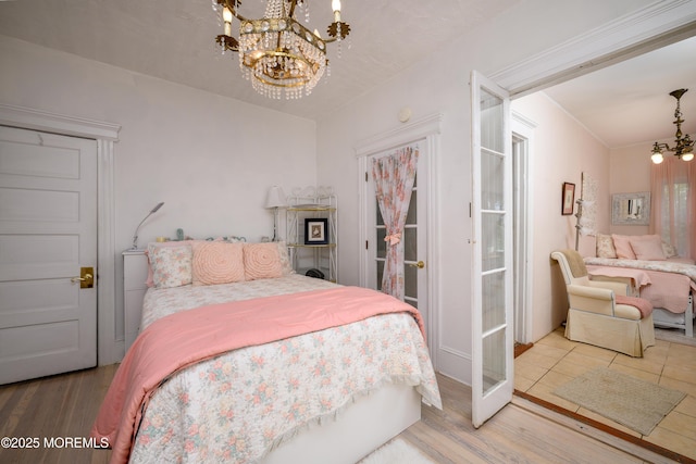 75 Highland Ave, Highlands, NJ 07732 - bedroom featuring an inviting chandelier and wood finished floors