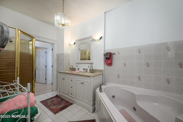 75 Highland Ave, Highlands, NJ 07732 - bathroom with a sink, a jetted tub, tile walls, double vanity, and a chandelier