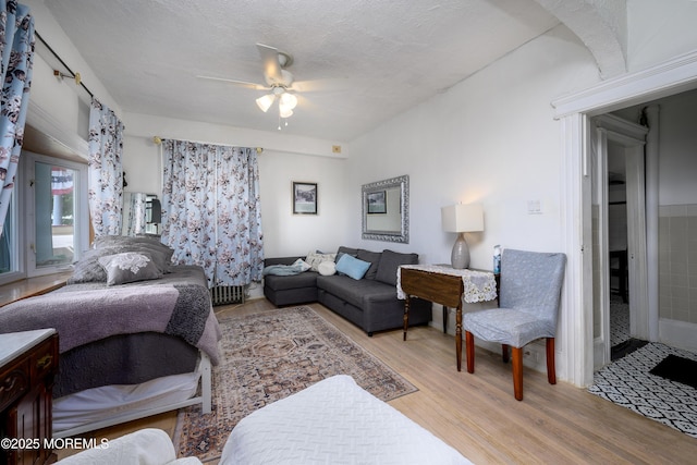 75 Highland Ave, Highlands, NJ 07732 - bedroom with a textured ceiling, wood finished floors, and a ceiling fan