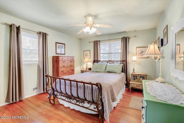 bedroom featuring ceiling fan, light wood finished floors, and baseboards