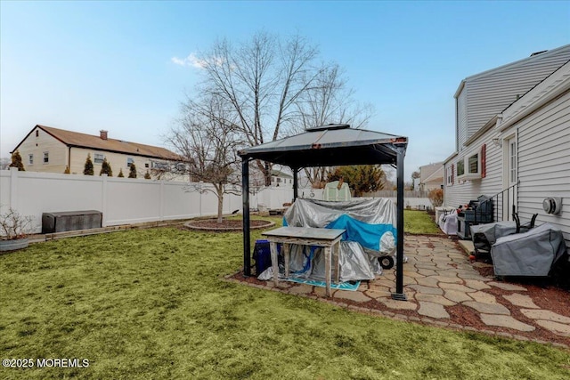 view of yard featuring a gazebo and a fenced backyard