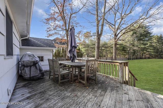 deck featuring outdoor dining space, a lawn, fence, and grilling area