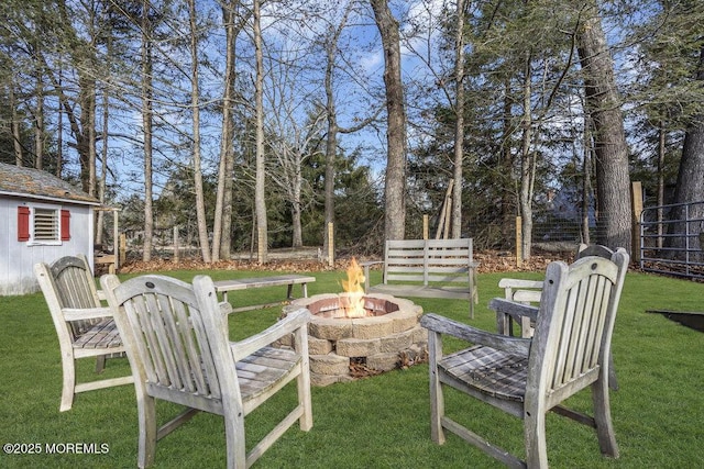 view of yard with a fire pit and fence