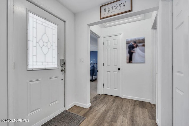 foyer with wood finished floors and baseboards