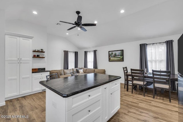 kitchen with dark countertops, visible vents, and light wood finished floors