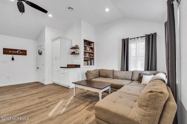 living room featuring light wood finished floors, visible vents, vaulted ceiling, recessed lighting, and a ceiling fan