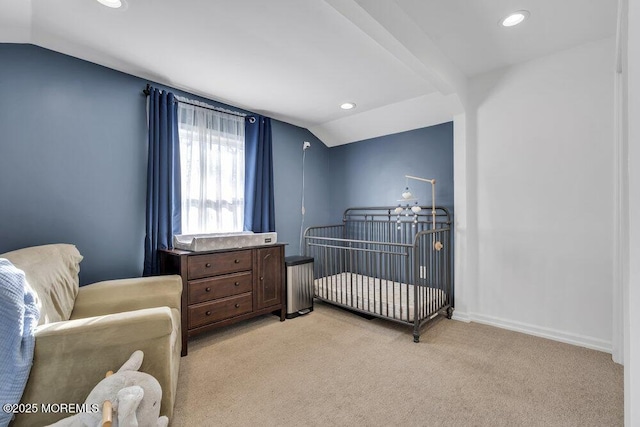 bedroom featuring baseboards, light colored carpet, lofted ceiling with beams, recessed lighting, and a nursery area