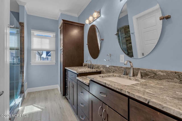 bathroom featuring a shower stall, crown molding, baseboards, wood finished floors, and vanity