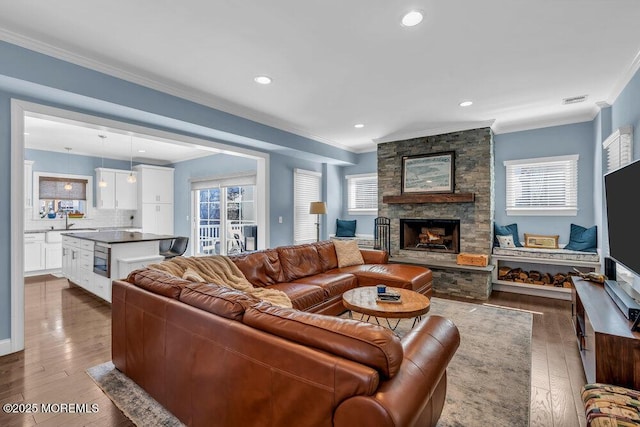 living room featuring a wealth of natural light and ornamental molding