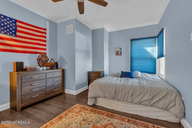 bedroom with visible vents, baseboards, ornamental molding, and dark wood-style flooring