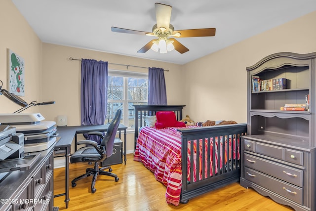 bedroom with light wood-style flooring and ceiling fan