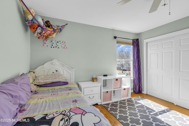 bedroom featuring a closet, wood finished floors, and a ceiling fan