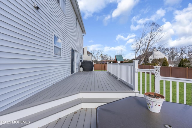 deck with a lawn, area for grilling, and fence