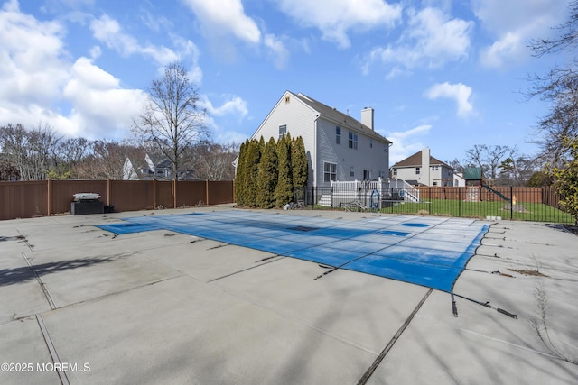 view of pool with a patio area, a playground, fence, and a fenced in pool