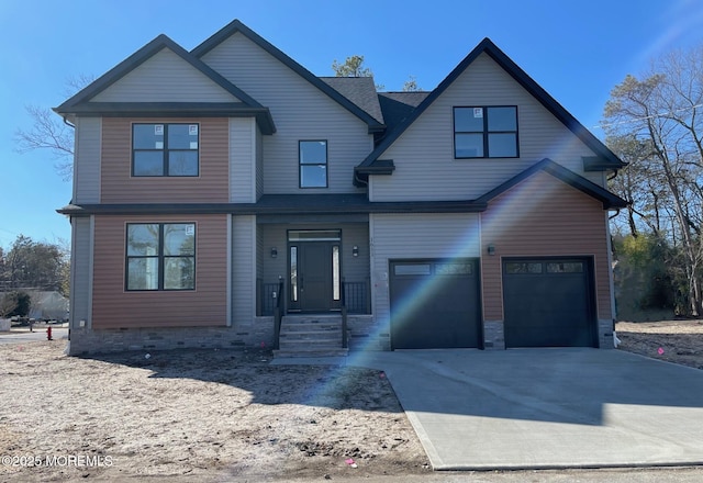 view of front of property with concrete driveway and an attached garage