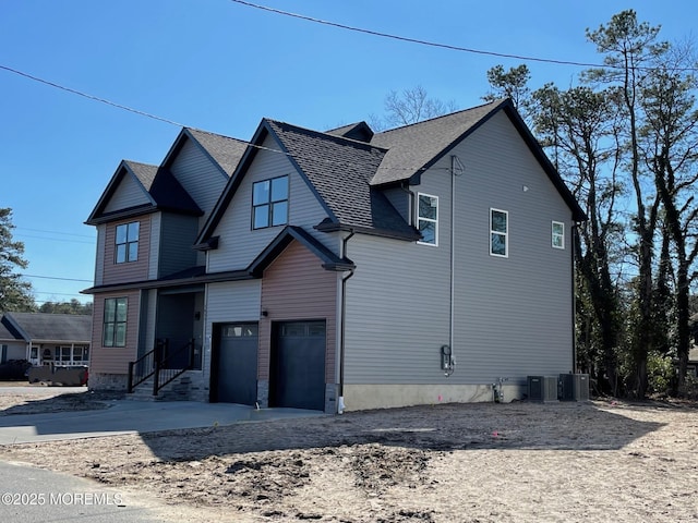 view of front facade with a garage and cooling unit