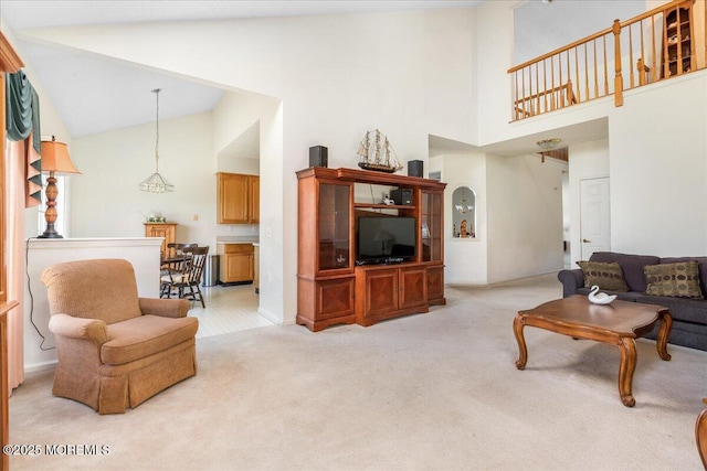 living area featuring high vaulted ceiling and light colored carpet